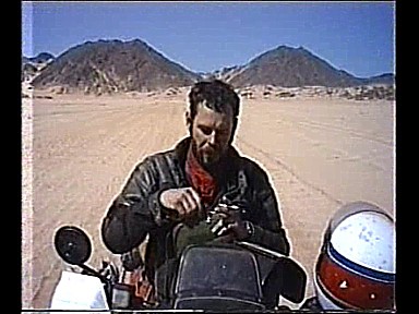 1986-South Algeria-desert-Jochen-short rest-important to drink water_out of my movie at YouTube-click above_Jochen A. Hbener